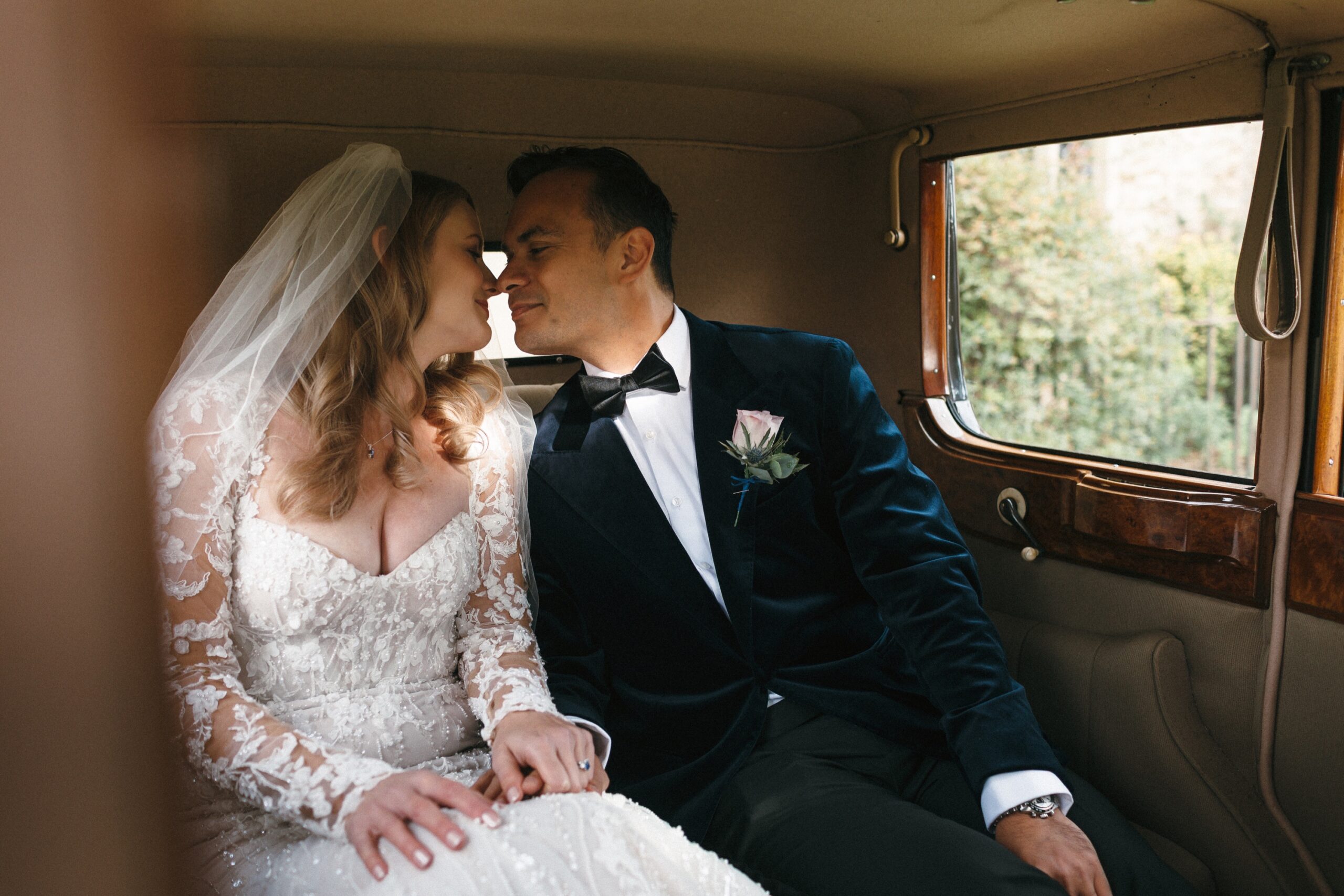 Bride and groom in vintage car at Orchardleigh House Wedding