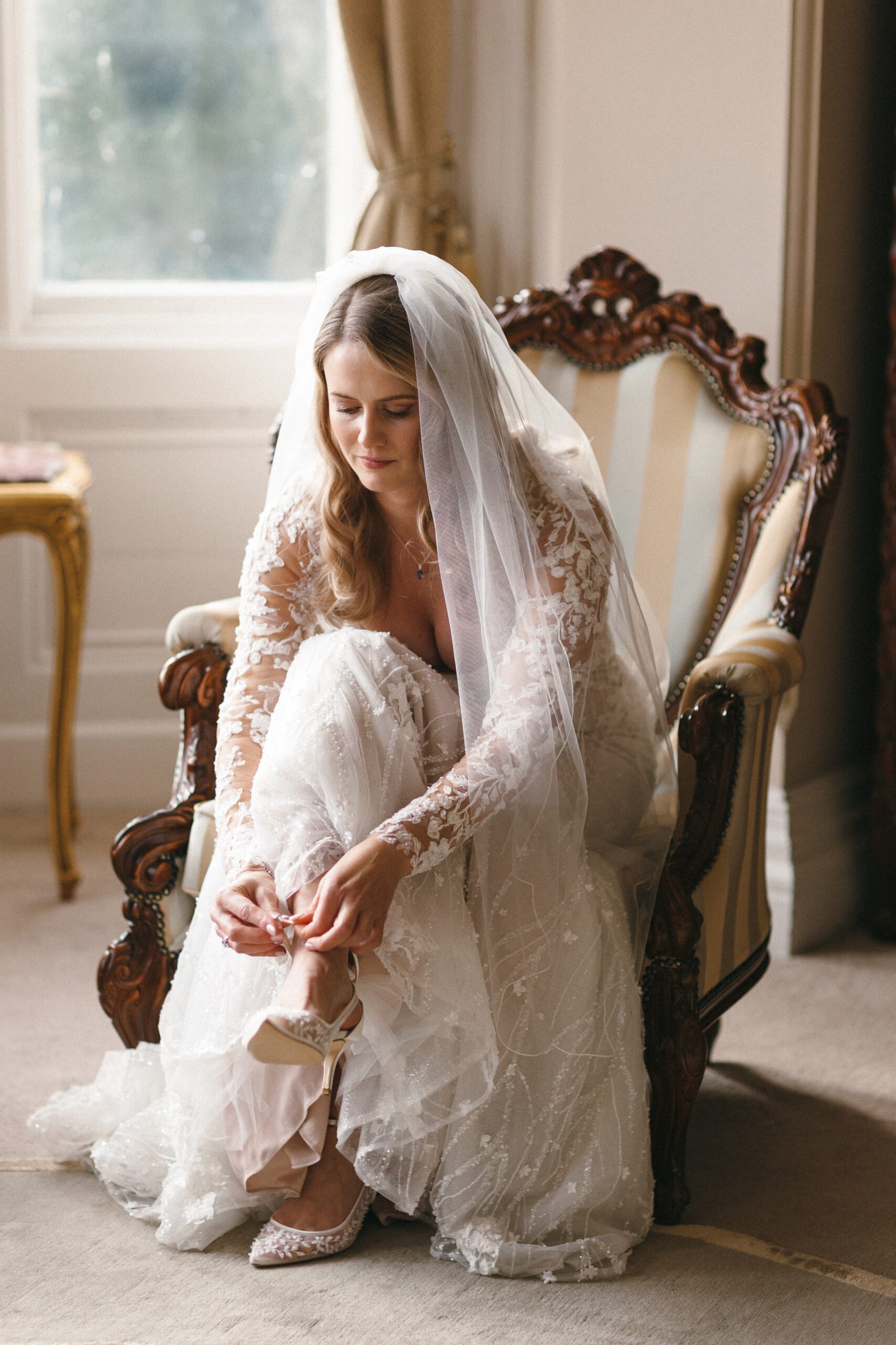 Bride prepares for her wedding at Orchardleigh House in Somerset